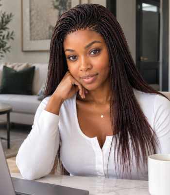 Busy Black professional woman wearing a polished micro-braided wig while working from a modern home office